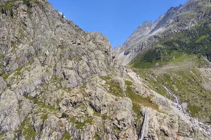 Rocky alpine trail leading to Trift Suspension Bridge, Swiss Alps hiking highlight on Zurich day trip