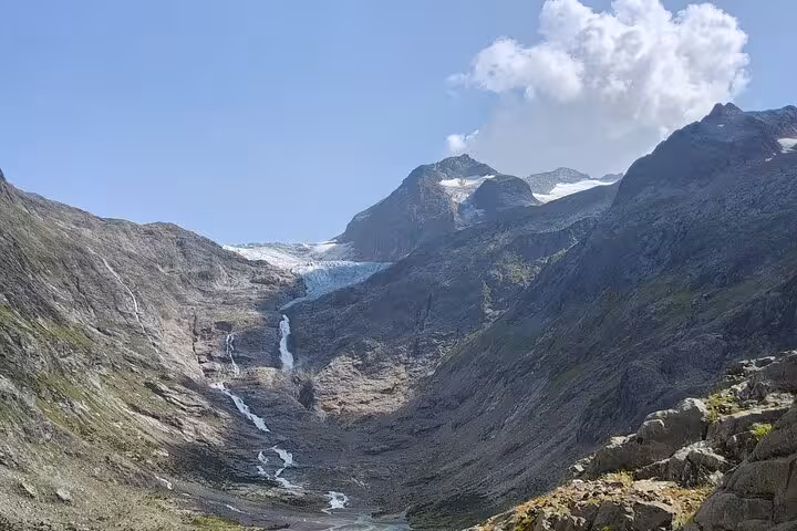 Swiss Alps panorama near Trift, with glacier and waterfall on Zurich day trip to Trift Suspension Bridge