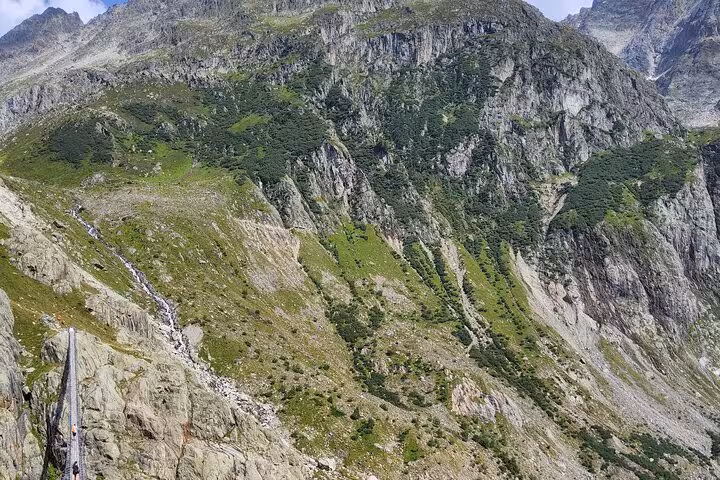 View over steep Swiss Alps valley near Trift, on Zurich day trip trek to the Trift Suspension Bridge