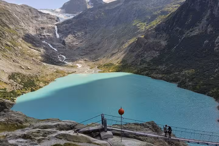 Trift Suspension Bridge viewpoint above turquoise Triftsee and glacier, scenic Zurich day trip in the Swiss Alps