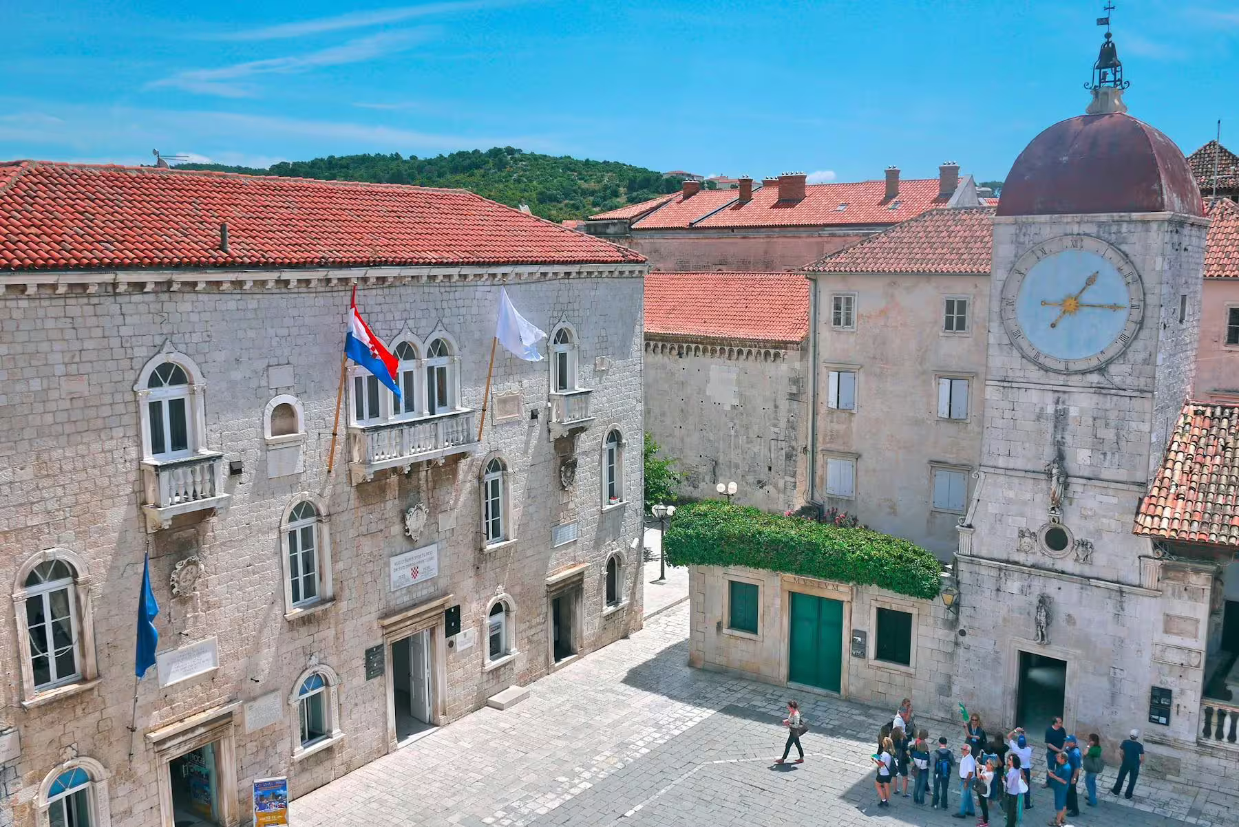 Trogir old town square with clock tower and red rooftops, scenic stop on day trip from Makarska Riviera