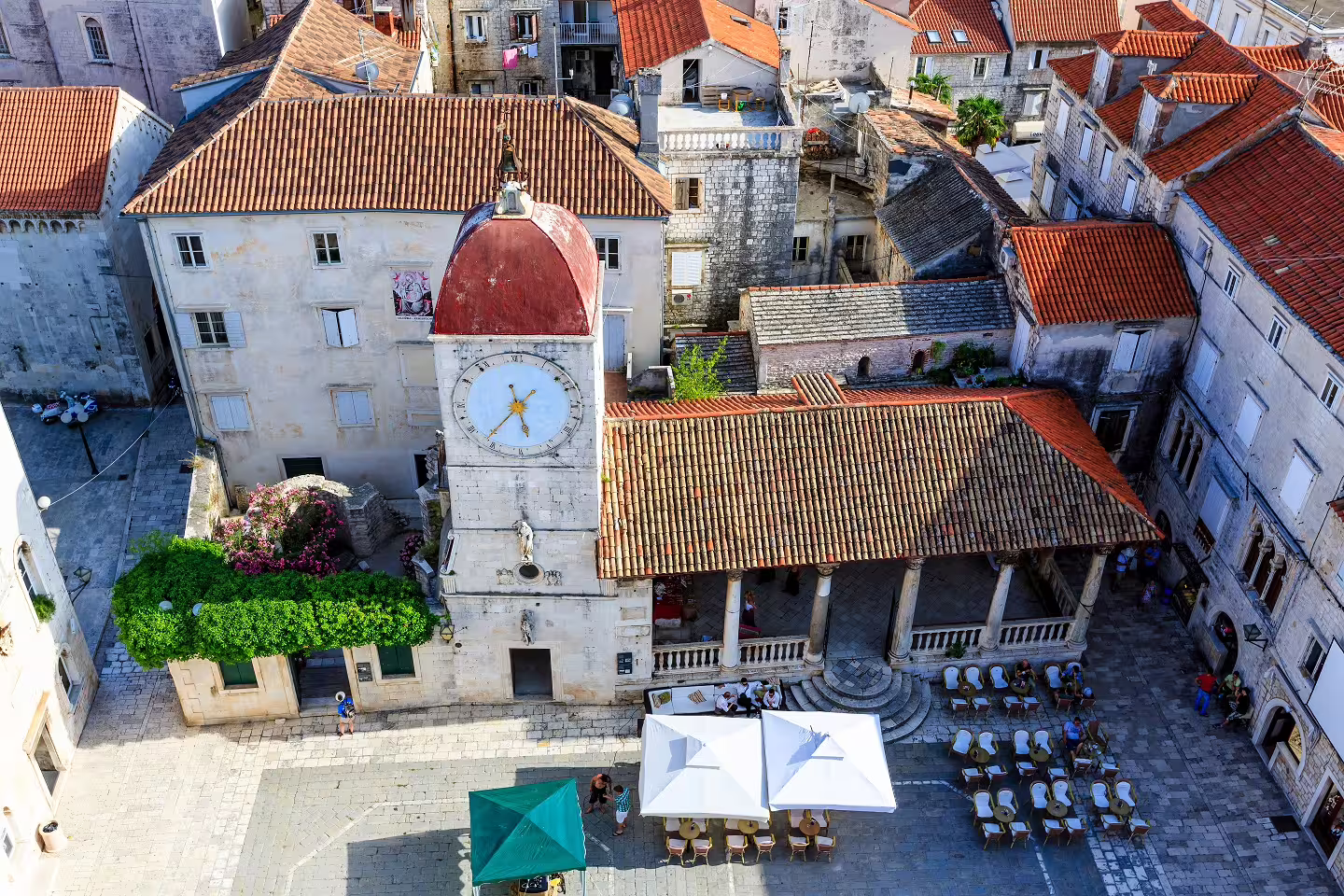 Aerial view of Trogir old town clock tower and red rooftops, a highlight on Dalmatian Coast self-drive tour