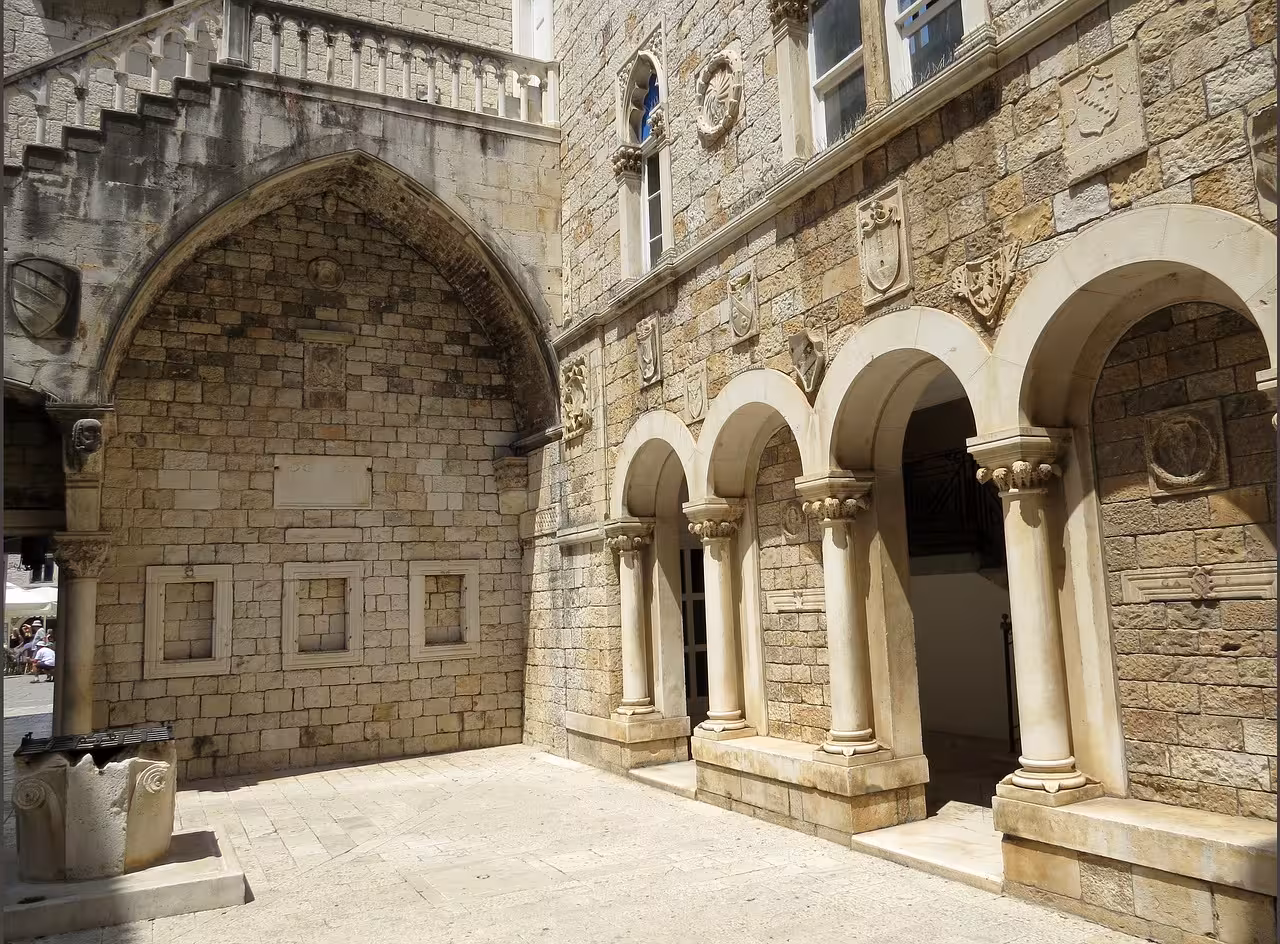 Stone arches and medieval courtyard in Trogir Old Town, exploring UNESCO heritage on the Klis Fortress tour