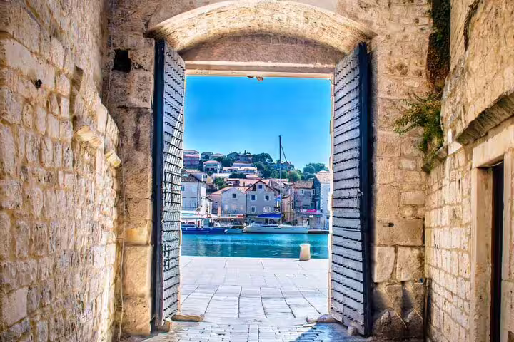 Stone archway view to Trogir waterfront and historic old town, Croatia on Krka Waterfalls and Trogir tour