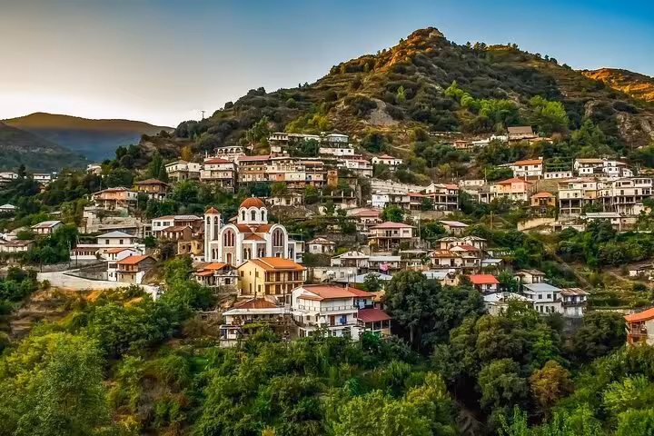 Traditional Troodos Mountains village with hillside homes and church, scenic stop on Kykkos Monastery tour
