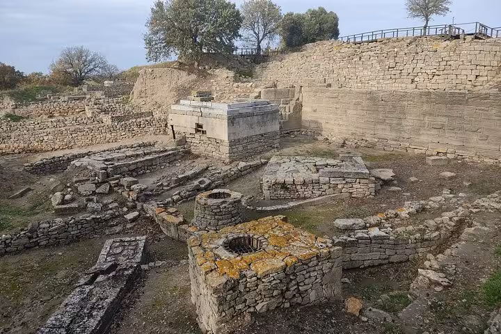 Ancient ruins and stone foundations at Troy archaeological site on full-day tour from Istanbul with lunch