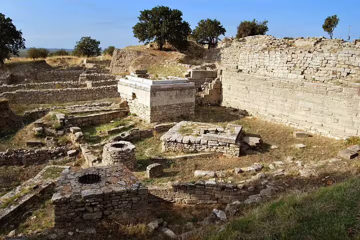Ruins of Troy archaeological site with ancient stone walls and trenches, stop on 7-day Western Turkey mini group tour