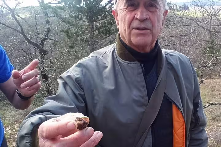 Guest proudly holding a freshly found truffle during guided truffle hunting experience in the Tuscan countryside