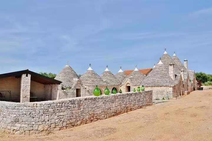 Traditional stone trulli farmhouse complex near Alberobello visited on a private day trip from Naples through rural Puglia