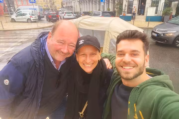 Happy guests with driver beside tuk tuk in Lisbon, a fun start to Sintra Cascais palaces and coast tour