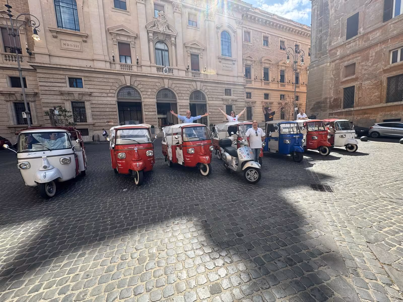 Vibrant tuk-tuks parked in a historic Italian square, perfect for exploring Rome's sights during the TEST experience.