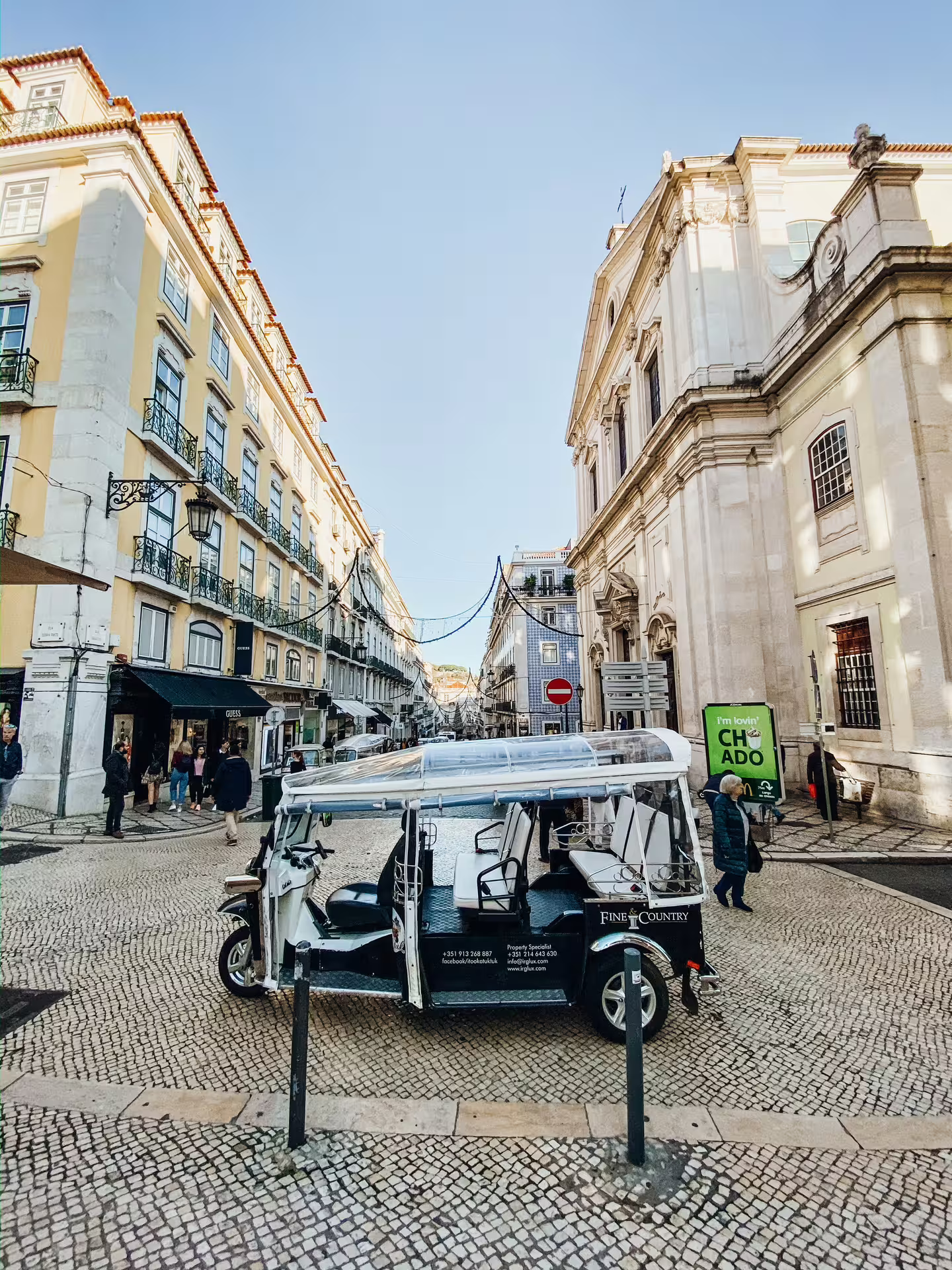 Tuktuk parked in Lisbon's medieval streets, showcasing historic architecture during a 3-hour city tour.