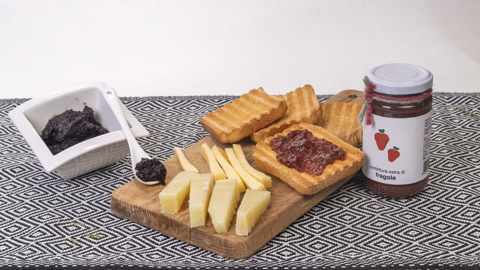 Delicious Tula jam tasting set with cheese, toast, and strawberry jam on a decorative board.