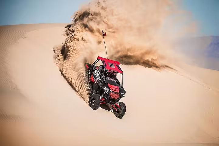 Thrill-seekers carve through the Tunisia Sahara sand dunes on a high-speed buggy adventure.