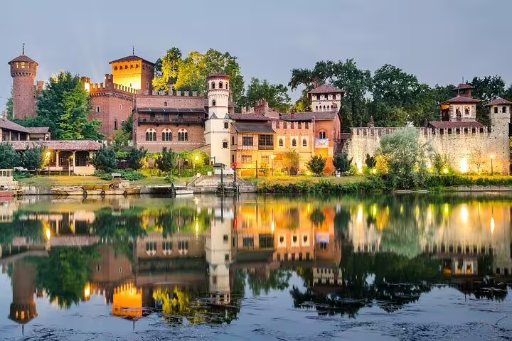 Romantic twilight view of Turin’s Borgo Medievale castle reflected in the Po River on a private top sights walking tour