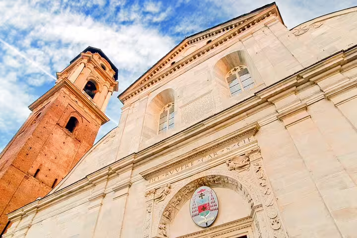 Turin Top Sights private guided walking tour visiting the historic Turin Cathedral and bell tower under a bright blue sky