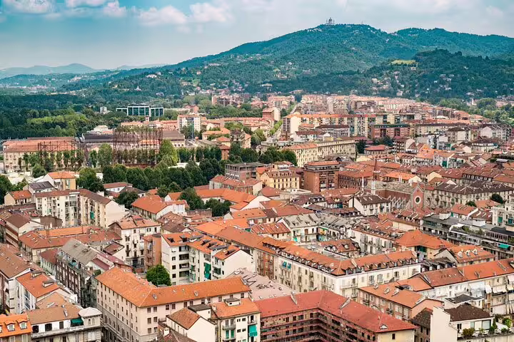 Panoramic Turin cityscape with red rooftops and hills, ideal for a self-guided scavenger hunt tour