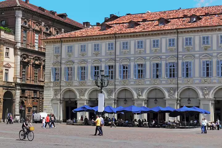 Travelers on a Turin Top Sights private walking tour exploring elegant piazza arcades and café terraces in the city center