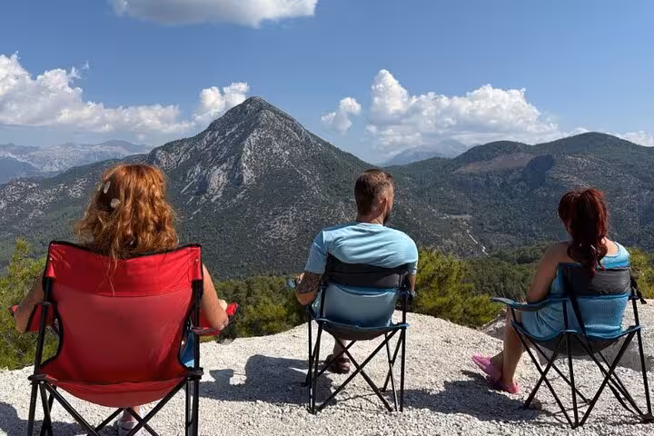 Tourists enjoy breathtaking mountain views from a scenic overlook in Turkey’s picturesque village landscapes.