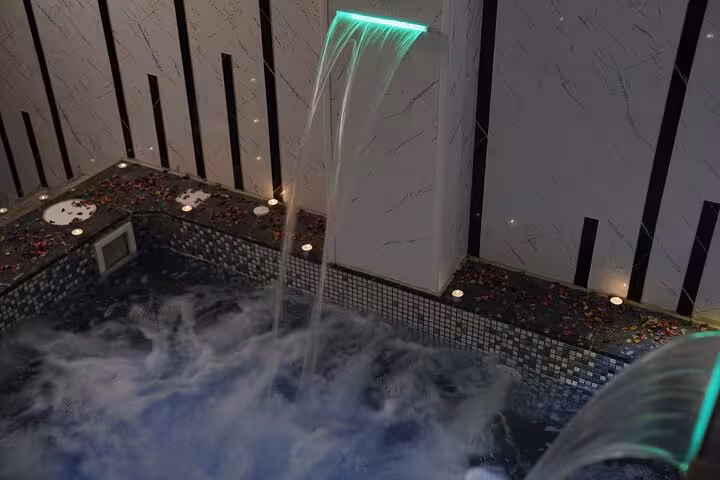 Waterfall jets flowing into bubbling jacuzzi at Turkish bath spa, Sharm El Sheikh full treatment experience
