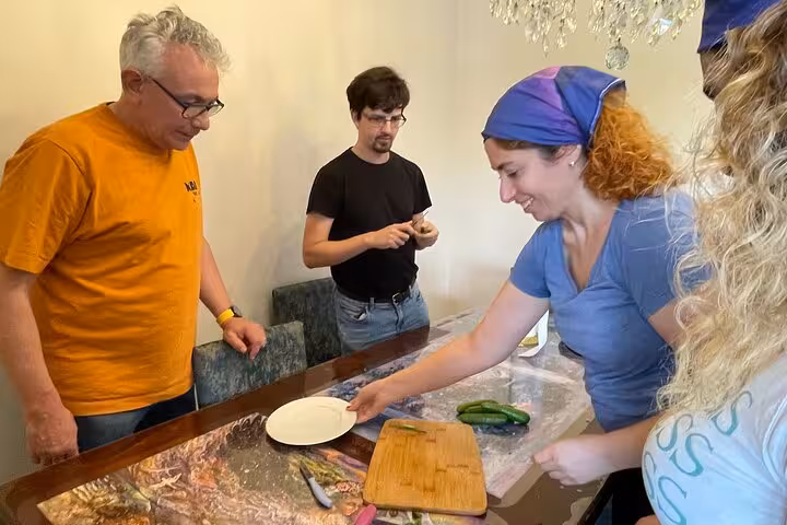 Host demonstrates prep at the kitchen table during an authentic Turkish cooking class in a local Istanbul home