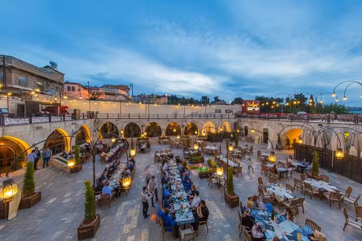Evening dining in a historic Turkish courtyard restaurant, ideal stop on famous Turkish cuisine tour