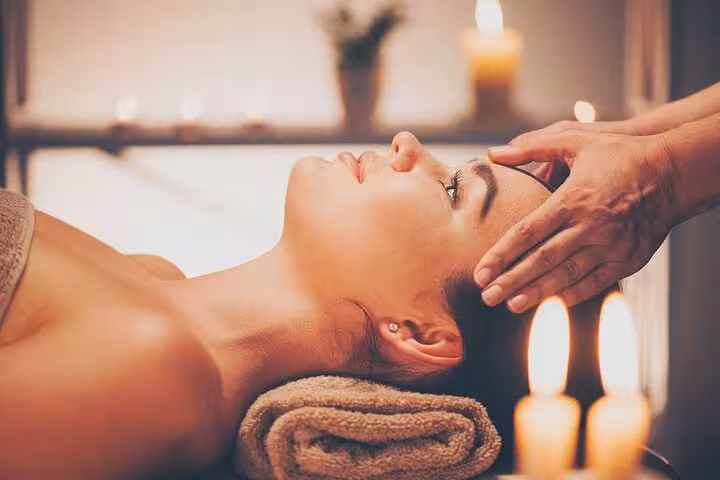 Woman enjoying head and face massage at Turkish hammam in Sharm El Sheikh with hotel pickup