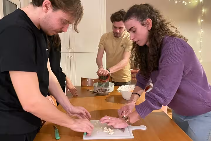 Travelers chopping garlic and prepping Turkish meze at a hands-on beginners cooking class in Istanbul