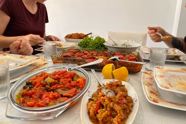 Close-up of homemade Turkish meze and oven-baked dishes on the table during an Istanbul family dinner experience
