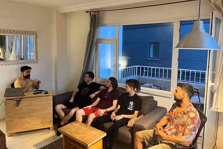 Small group networking Turkish tea tasting in Istanbul apartment lounge, host leading Sip & Connect chat