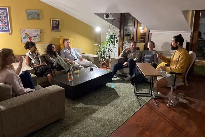 Group networking over Turkish tea in an Istanbul living room, tasting session with local host and travelers