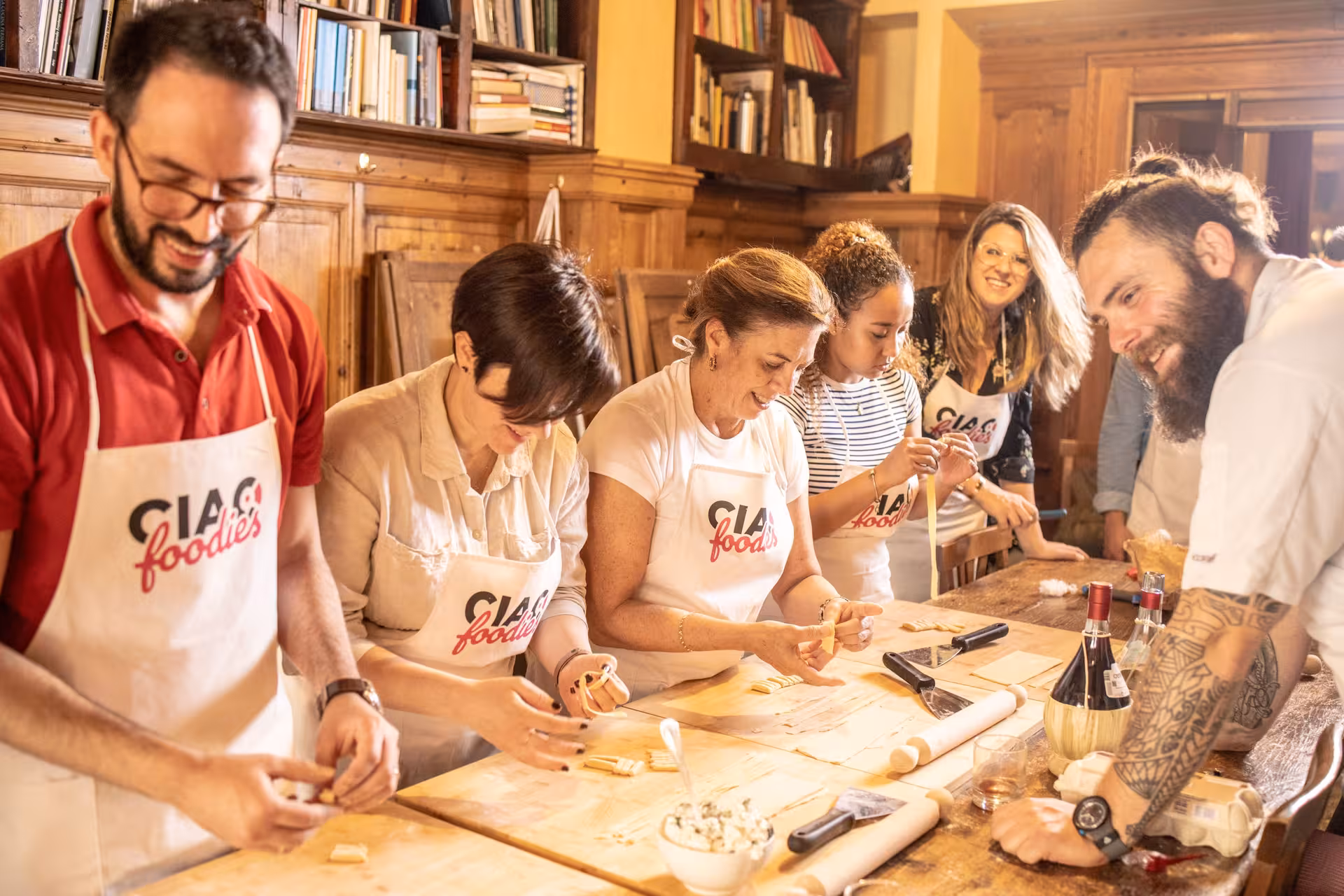 Group enjoys hands-on Tuscan cooking class in Florence, crafting pasta together.