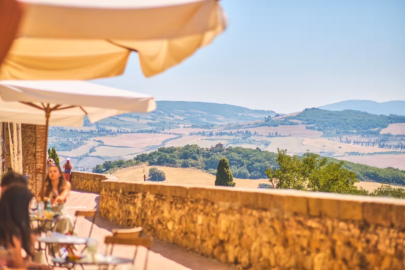 Scenic view of Tuscan countryside from a terrace cafe during the Land of Brunello wine tour.