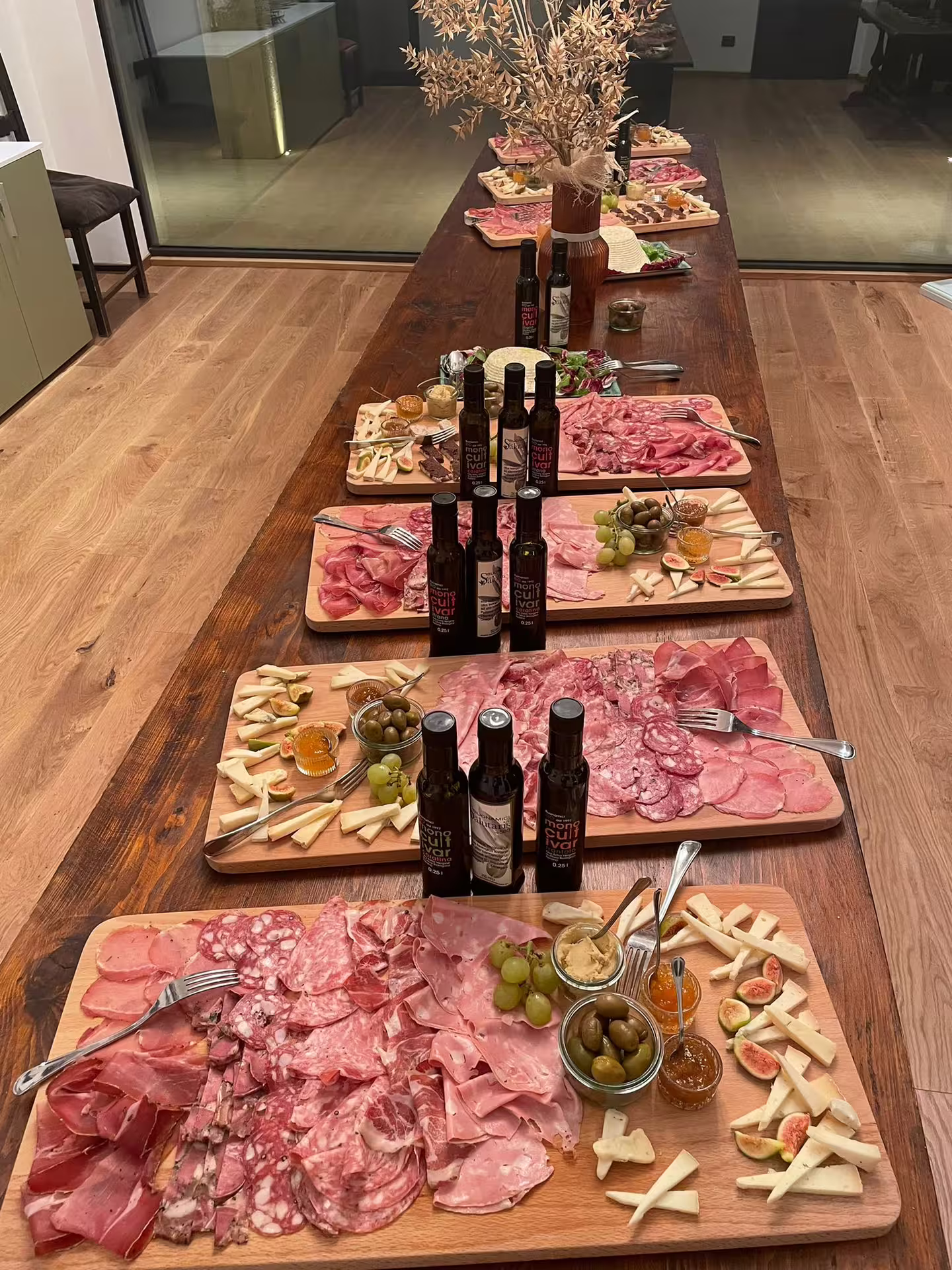 Tuscan charcuterie and cheese boards with EVO oil bottles at Frantoio Buonamici Fiesole tasting