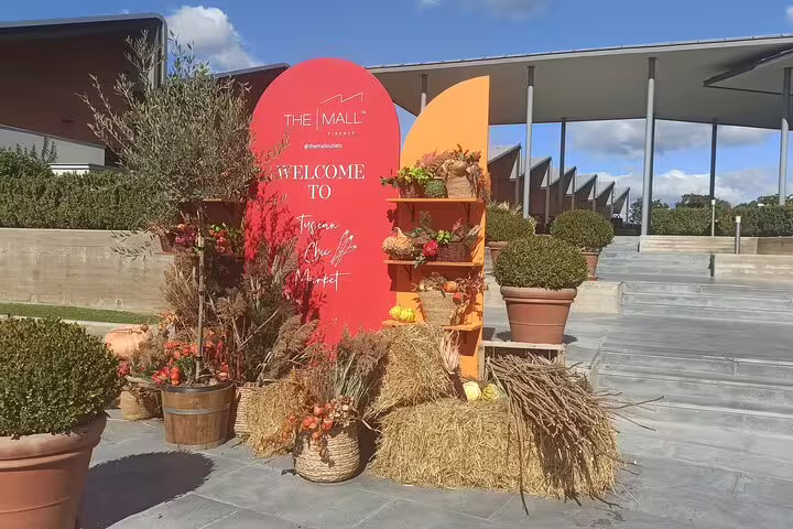 Colorful Tuscan-style welcome display at The Mall luxury outlets, perfect photo stop on private chauffeur shopping tour