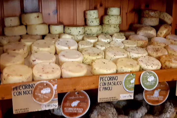 Selection of Tuscan pecorino cheeses in a Volterra shop, a gourmet tasting stop on a Livorno wine and food tour