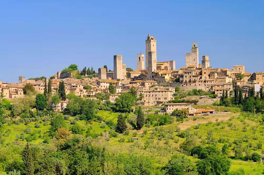 Experience the lush countryside and historic towers of San Gimignano on a Tuscany day trip with wine and food tasting.