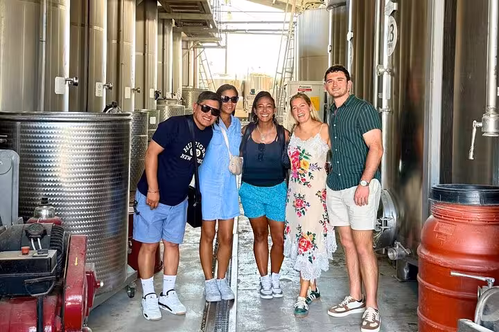 Tourists enjoying a wine tasting tour in Tuscany, part of the From Florence 2-Day Combo Tour.