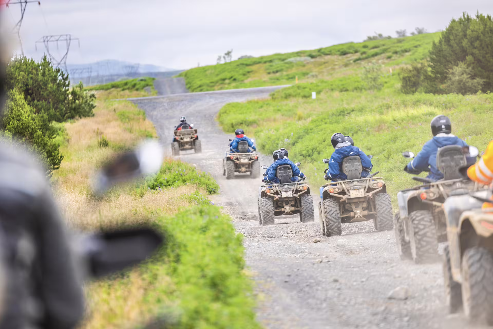 Group of riders on ATVs exploring scenic green trails during the 2 Hour Twin Peaks adventure tour, perfect for thrill-seekers.