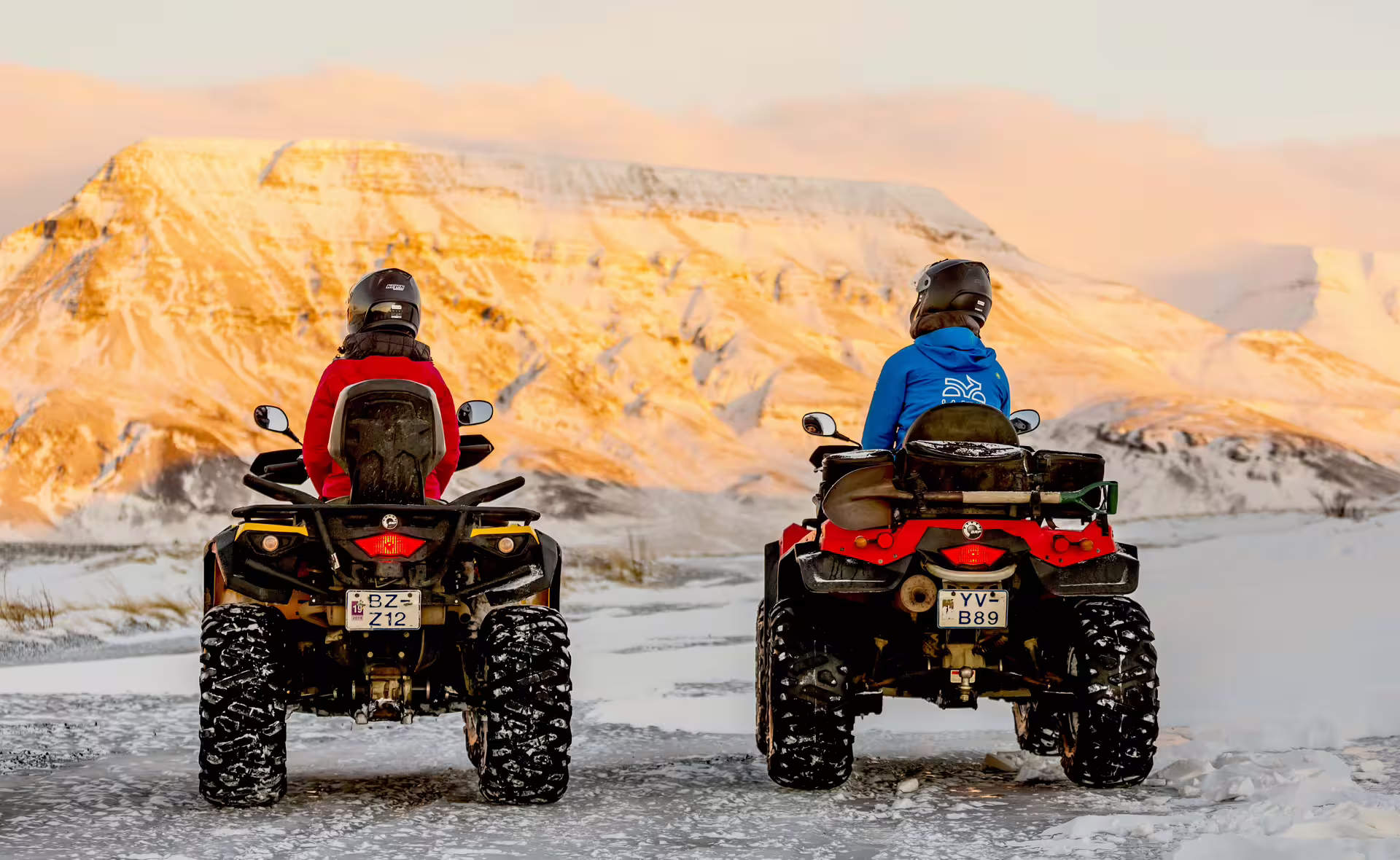ATV riders explore snowy landscapes with sunset-lit mountains on the 2 Hour Twin Peaks adventure tour.