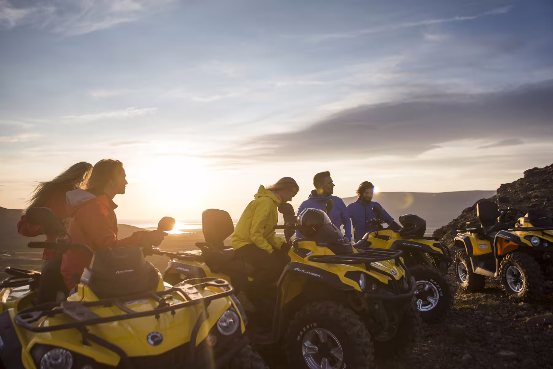 Adventure seekers enjoy a scenic sunset view atop yellow ATVs on the Twin Peaks two-hour tour, highlighting outdoor thrill.