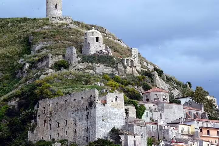 Hilltop medieval ruins above pastel houses on the Tyrrhenian Sea coast, visited on a guided walking tour with lunch