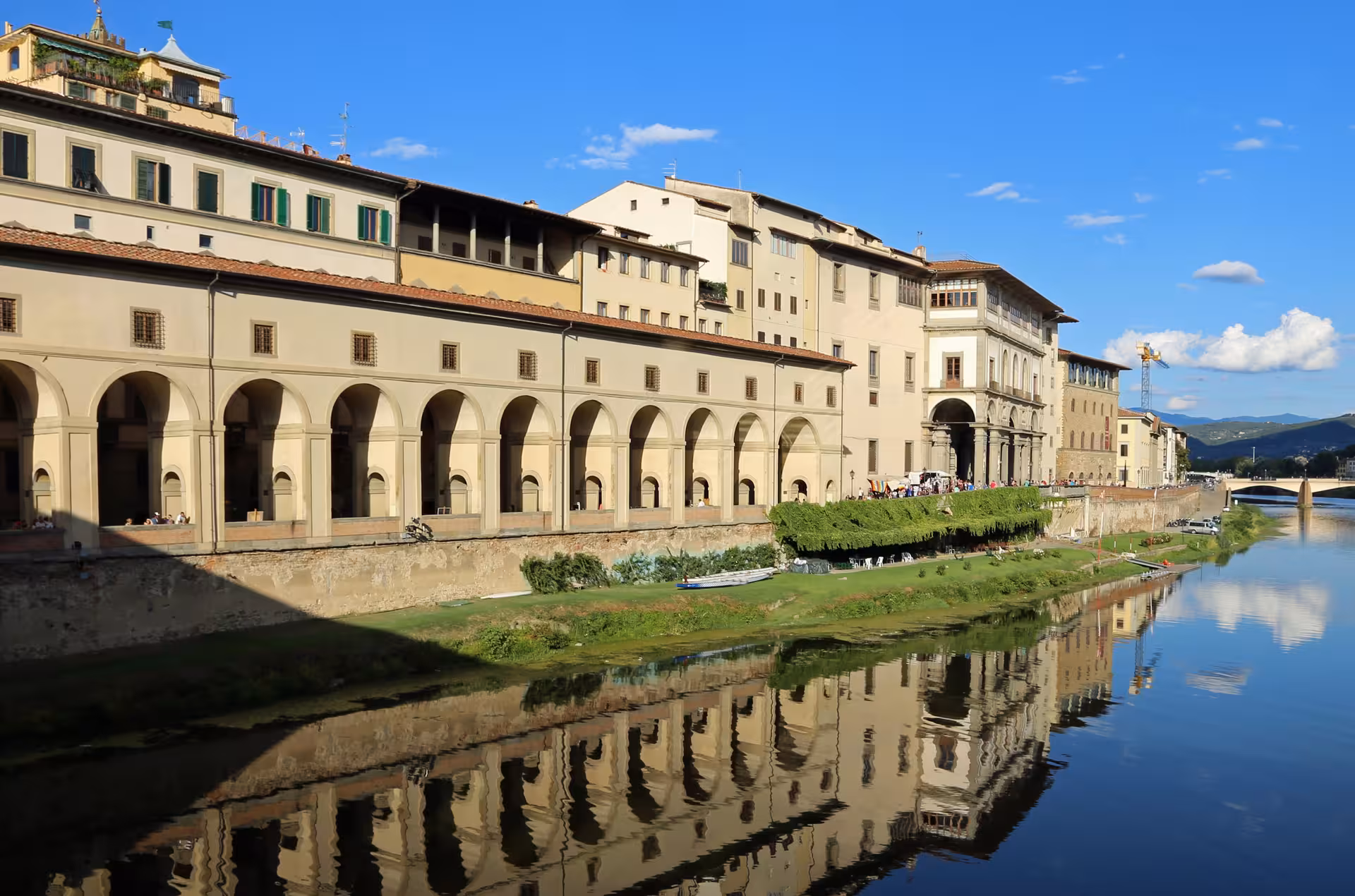 Scenic view of the Uffizi Gallery exterior along the Arno River in Florence, ideal for small group guided tours.