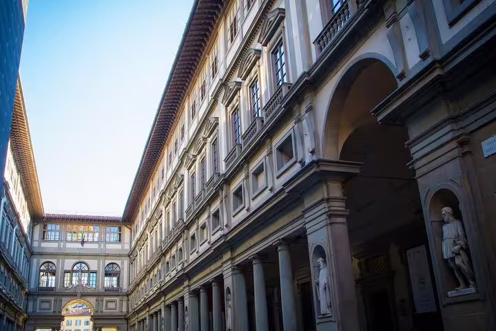 Perspective of the Uffizi Gallery colonnade and statues in Florence, captured on a small group tour with local guide