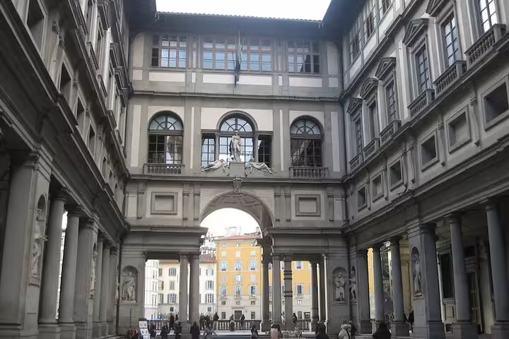 Entrance courtyard of the Uffizi Gallery in Florence with Renaissance arches and columns on a small group guided tour