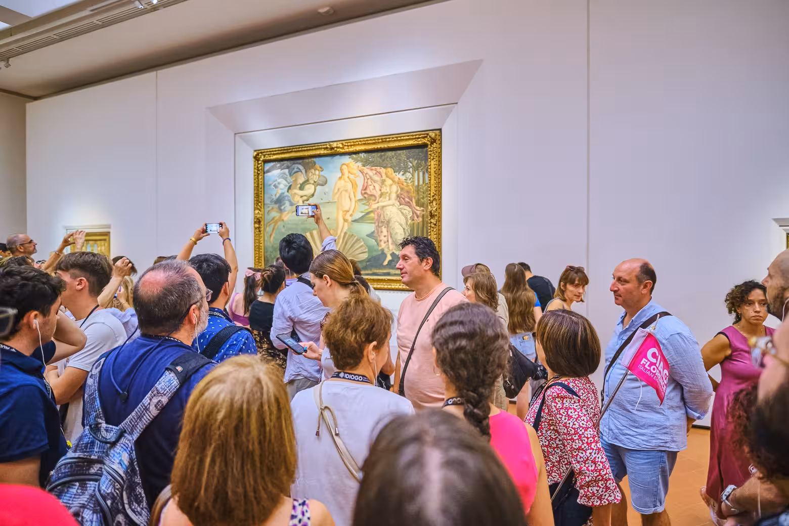 Visitors admiring famous Renaissance artwork inside the Uffizi Gallery during a guided tour.