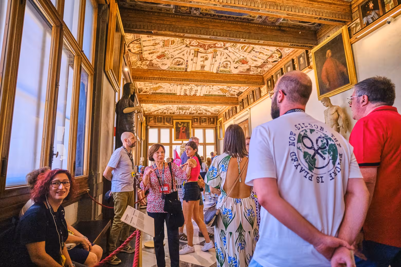 Visitors engage in a guided tour at the Uffizi Gallery, appreciating exquisite art and architecture on a private tour.