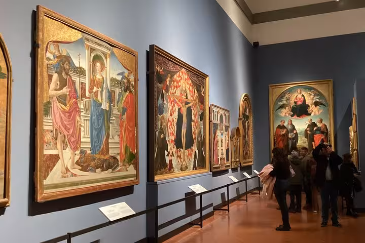 Renaissance masterpieces line the walls of the Uffizi Gallery in Florence, highlighting a guided tour experience.