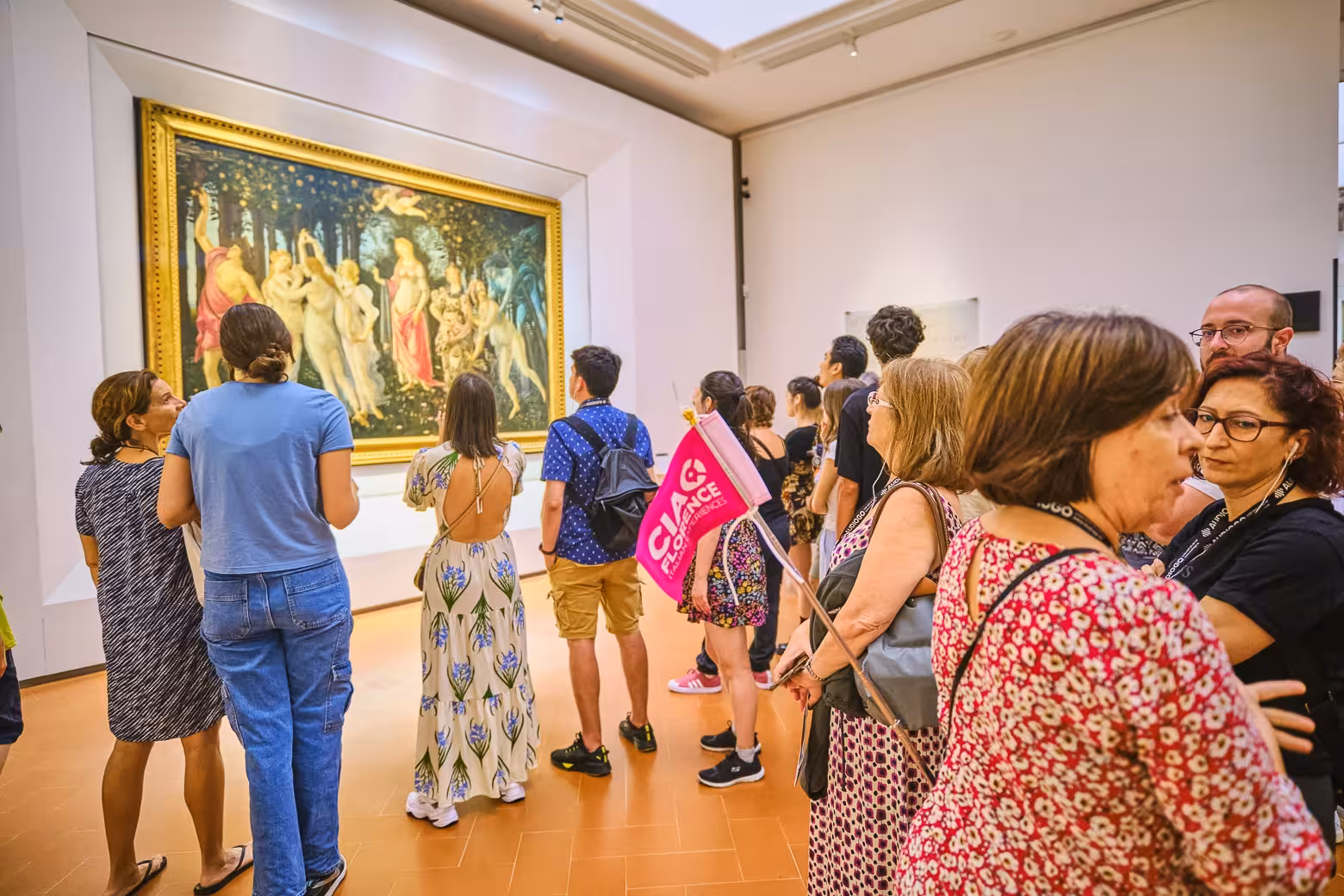Visitors explore iconic artwork in the Uffizi Gallery during a small group tour with skip-the-line access.