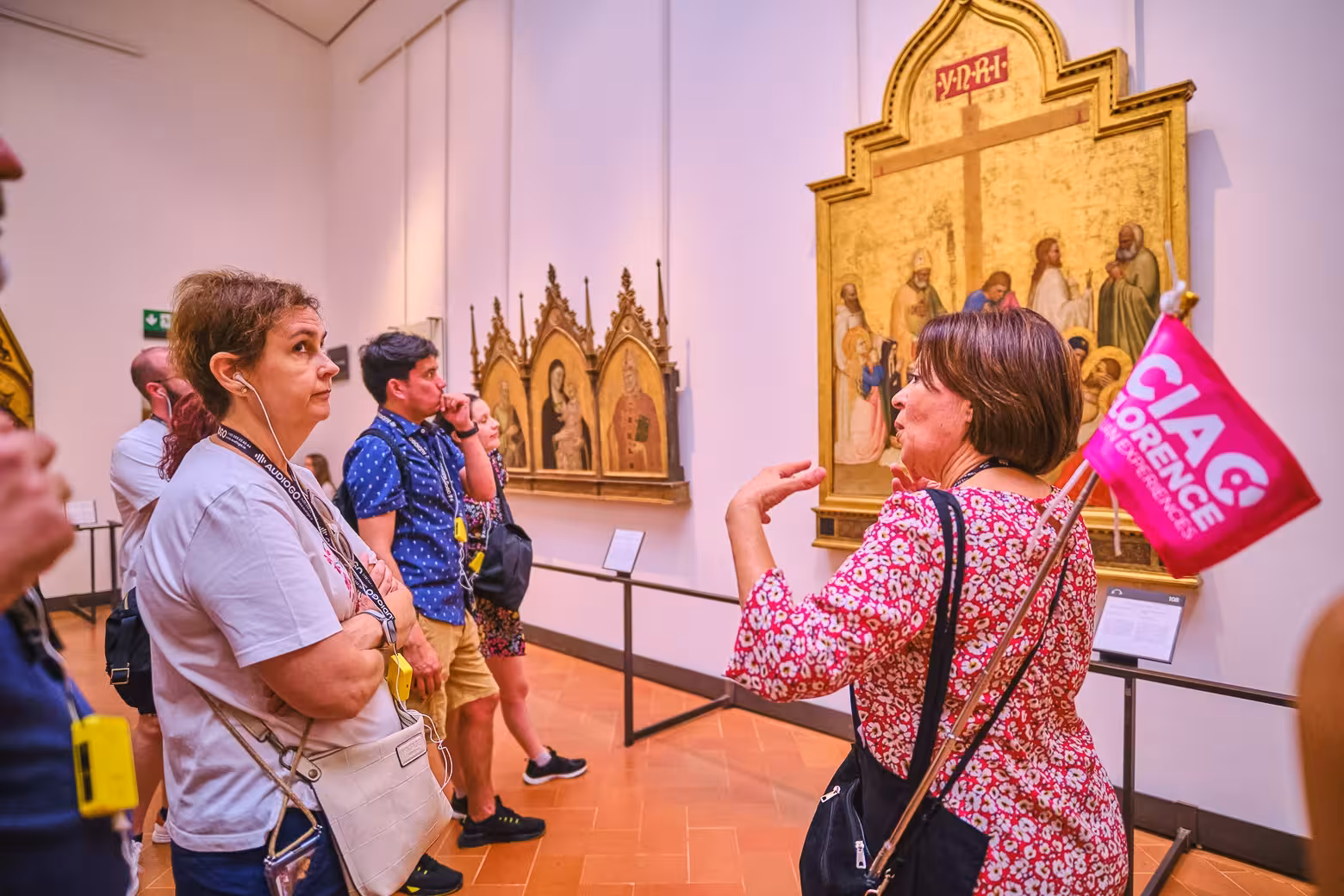 Visitors engage in lively discussion during Uffizi Gallery small group tour with skip-the-line Vasari Corridor access.